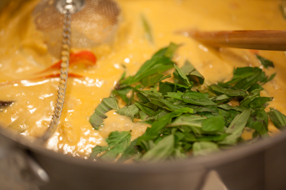 Thai basil added to red thai chicken curry just before serving
